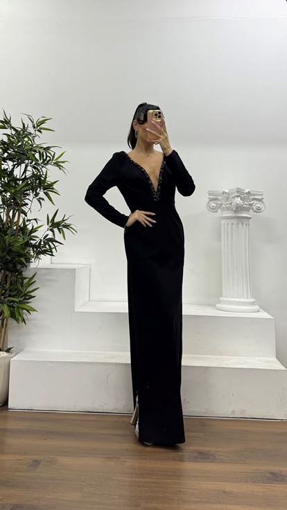 Schwarzes, tief eingefasstes, mit Steinen verziertes Abendkleid in besonderem Design